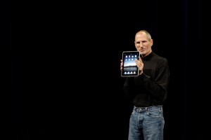 Steve Jobs holding an iPad